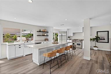 Remodeled white kitchen with quartz island at 24828 Acropolis Drive